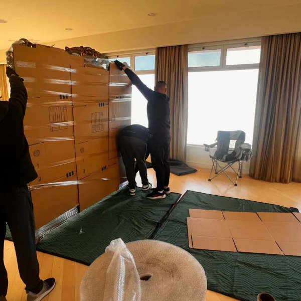 Titan Relocation furniture movers in Los Angeles County loading wrapped furniture into a moving truck safely and carefully